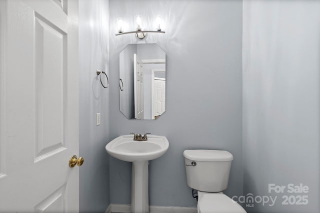 bathroom featuring sink and toilet