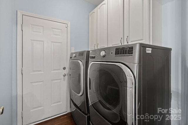 washroom with cabinets, dark hardwood / wood-style flooring, and independent washer and dryer