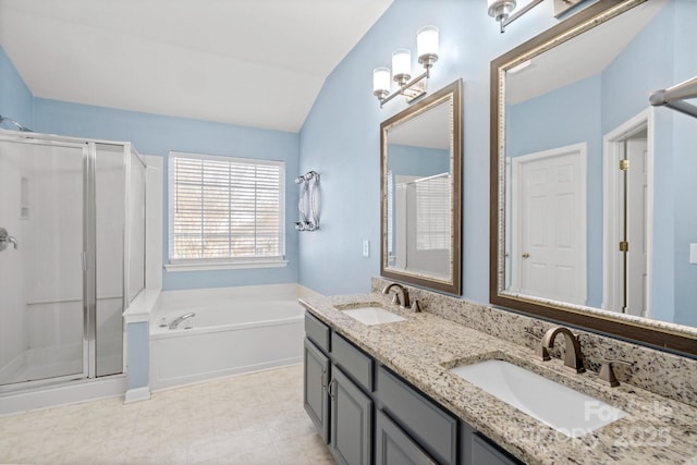 bathroom with vanity, shower with separate bathtub, and vaulted ceiling