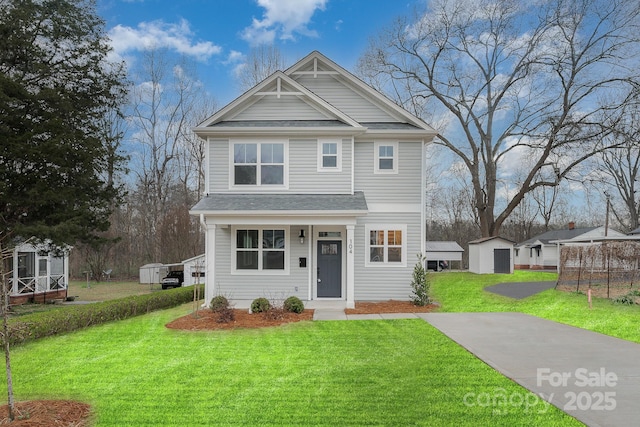 view of front facade featuring a storage unit and a front lawn