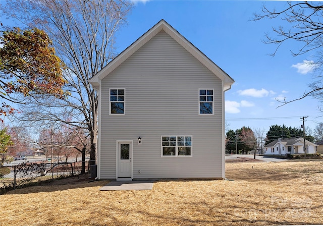 rear view of house with a yard