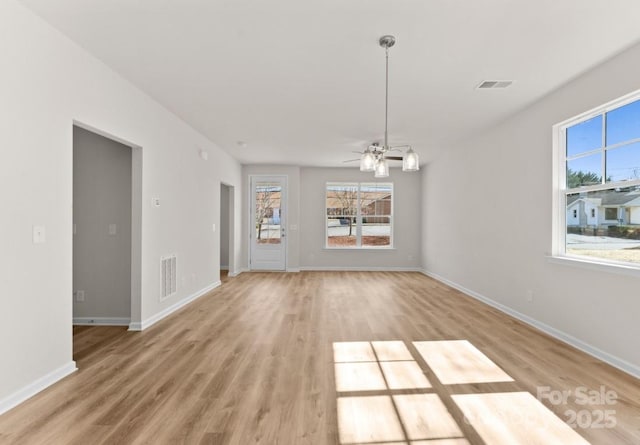 interior space with light wood-type flooring and ceiling fan