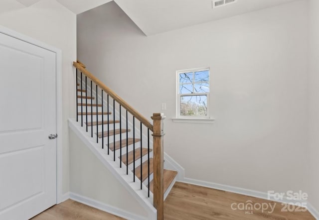 staircase featuring hardwood / wood-style flooring