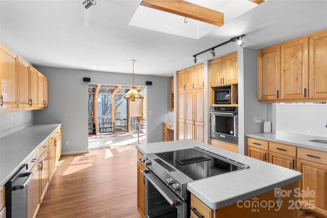 kitchen with light brown cabinetry, a kitchen island, pendant lighting, stainless steel appliances, and light hardwood / wood-style floors