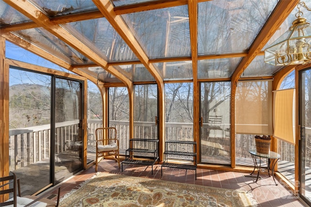 unfurnished sunroom featuring a wealth of natural light and beam ceiling