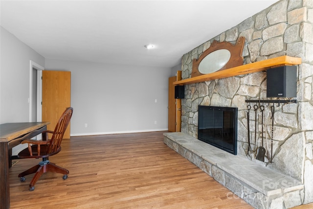 office area featuring hardwood / wood-style flooring and a fireplace