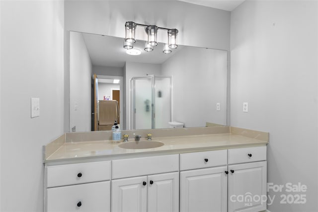 bathroom with vanity and a shower with shower door