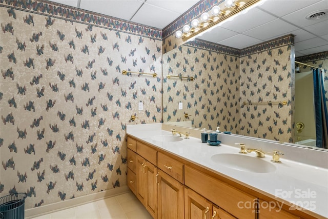 bathroom featuring vanity and a drop ceiling