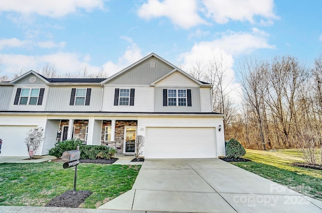 traditional home with a garage, concrete driveway, stone siding, a porch, and a front yard