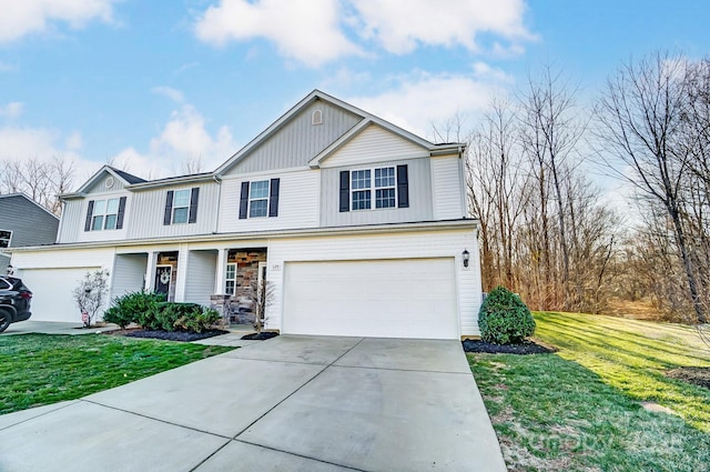 view of front facade featuring a garage, driveway, and a front lawn