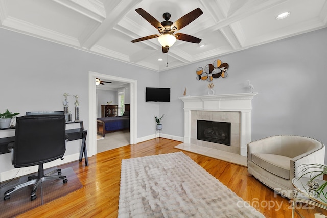 interior space with coffered ceiling, a fireplace, and wood-type flooring