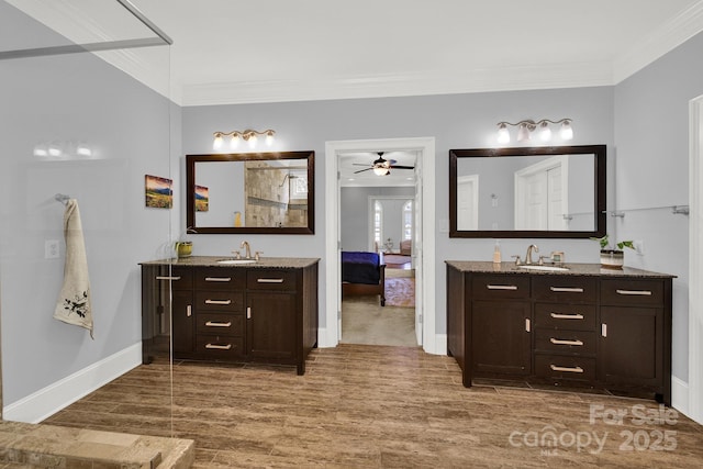 bathroom featuring crown molding, ceiling fan, vanity, and hardwood / wood-style floors