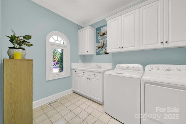 clothes washing area with sink, cabinets, light tile patterned floors, ornamental molding, and washer and clothes dryer