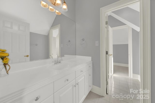 bathroom with lofted ceiling, vanity, and tile patterned flooring