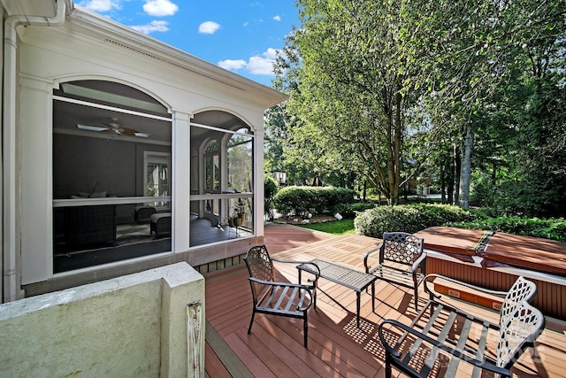 wooden deck with a sunroom and ceiling fan