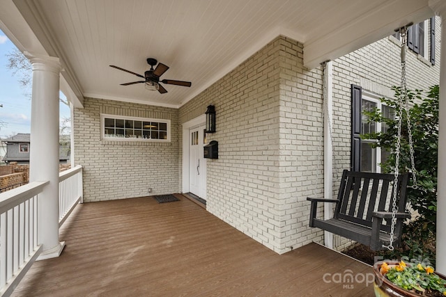 wooden deck with ceiling fan and covered porch