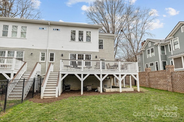 back of property with a wooden deck and a lawn