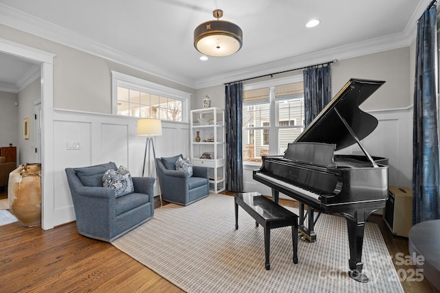 living area featuring crown molding and wood-type flooring