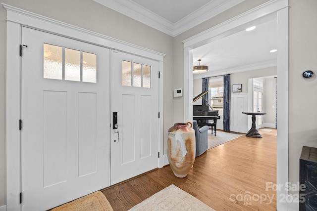 foyer featuring crown molding and wood-type flooring