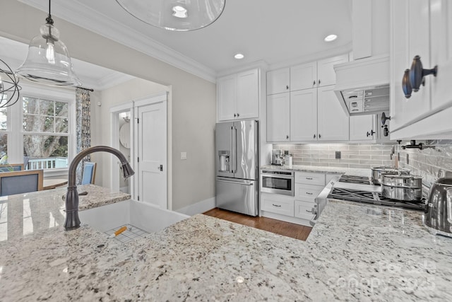 kitchen with white cabinets, light stone counters, stainless steel appliances, crown molding, and custom range hood