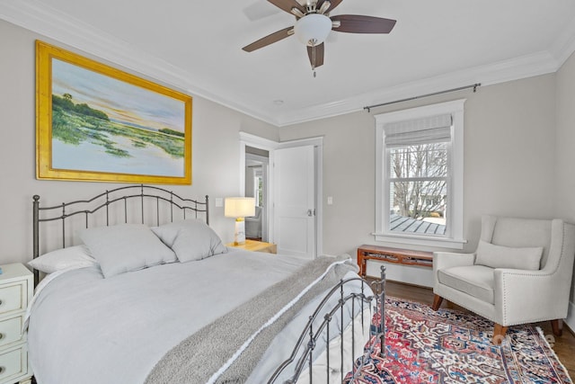 bedroom with ceiling fan, ornamental molding, and hardwood / wood-style floors