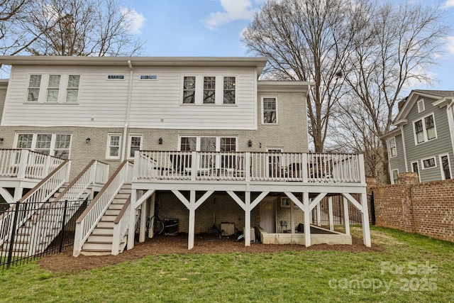 back of property with a wooden deck, a yard, and cooling unit