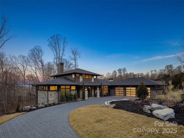 prairie-style home featuring a garage and a front yard