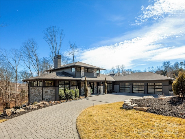 prairie-style home with a garage and a front yard