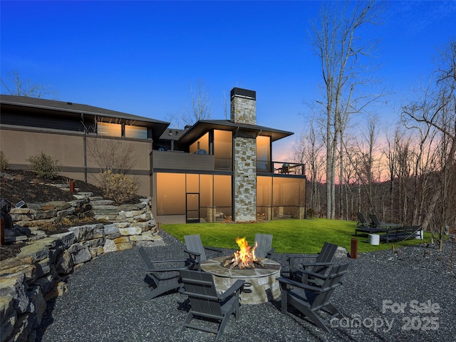 yard at dusk with a fire pit