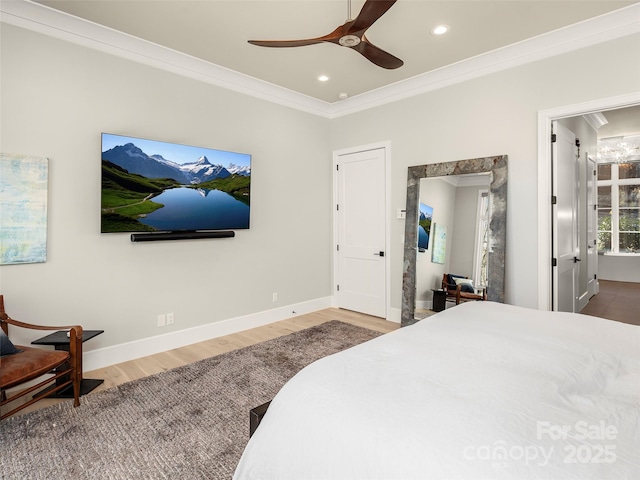 bedroom with crown molding, wood-type flooring, and ceiling fan