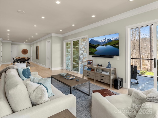 living room with crown molding and light hardwood / wood-style floors