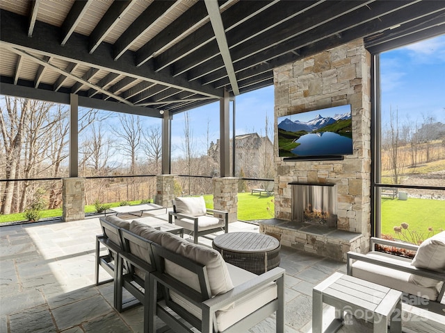 sunroom with an outdoor stone fireplace