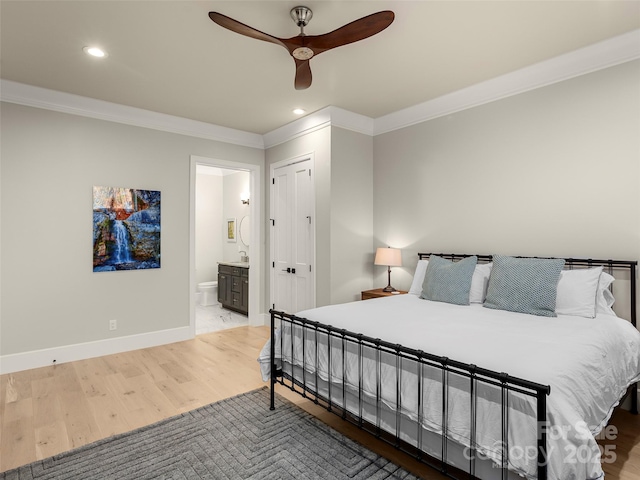 bedroom with crown molding, ceiling fan, connected bathroom, and light hardwood / wood-style floors