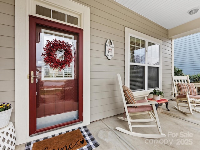 view of exterior entry with covered porch