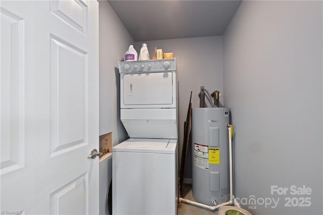 washroom featuring stacked washer / drying machine and electric water heater