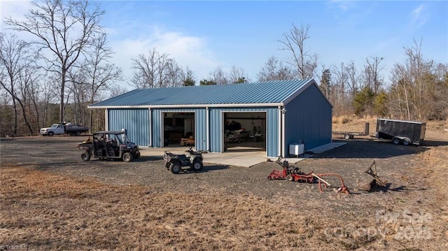 back of property featuring a garage and an outdoor structure