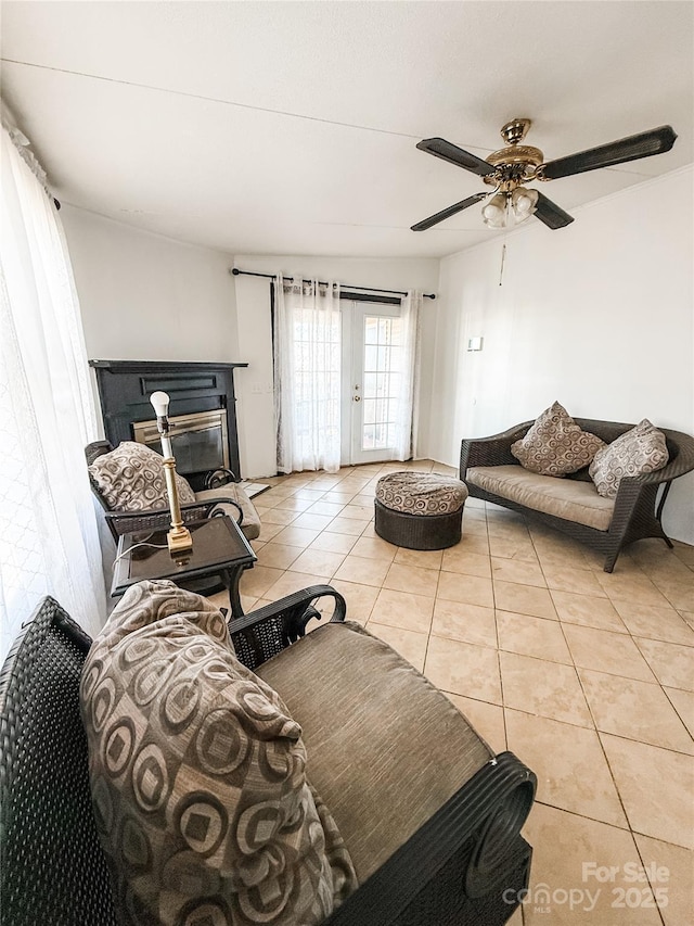 living room featuring light tile patterned floors and ceiling fan