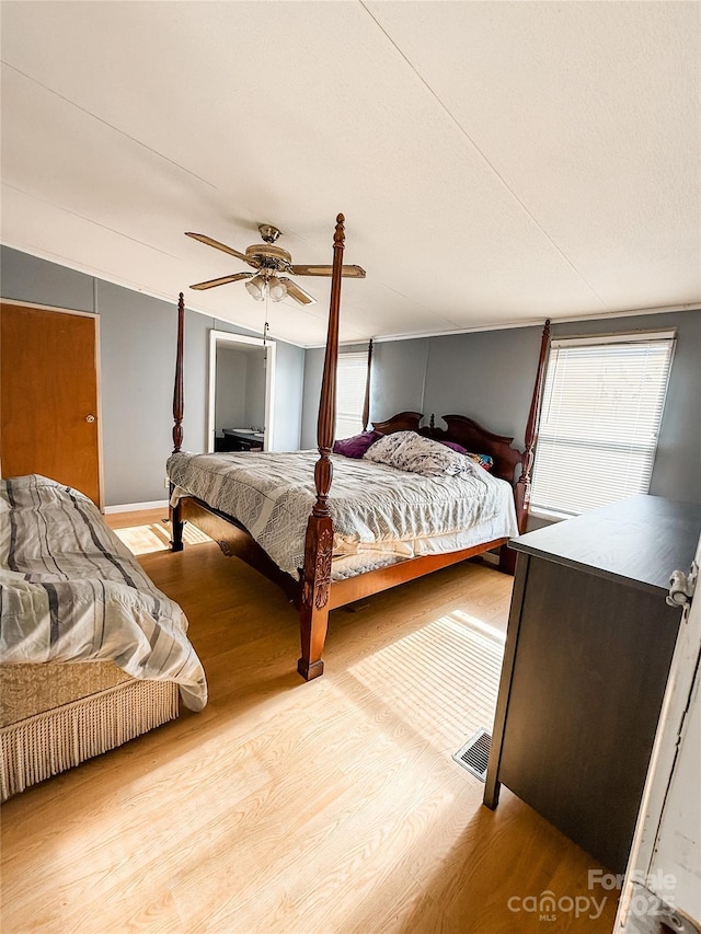 bedroom featuring light hardwood / wood-style floors and ceiling fan