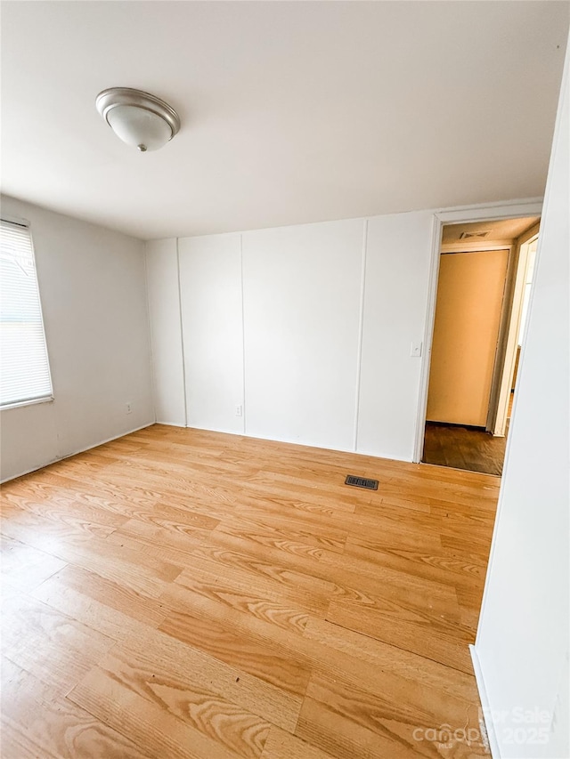 unfurnished room featuring light wood-type flooring