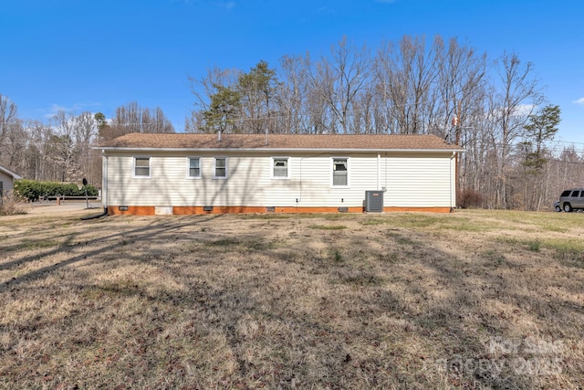 back of house with a yard and central AC unit