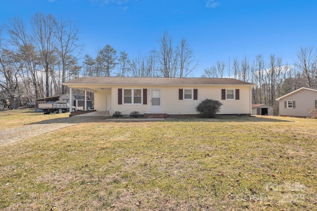 ranch-style home featuring a front yard and a carport