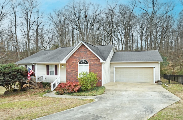 view of front of home with a porch, a garage, and a front lawn