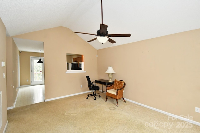 office space with lofted ceiling, light carpet, and ceiling fan