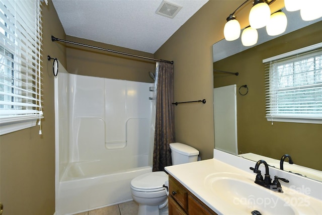 full bathroom with tile patterned flooring, vanity, toilet, shower / bath combo, and a textured ceiling