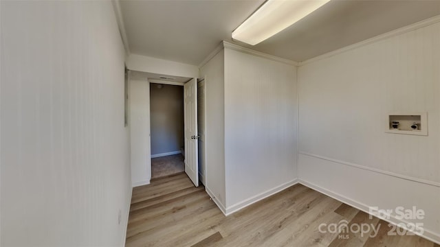 washroom with ornamental molding, light hardwood / wood-style floors, and hookup for a washing machine