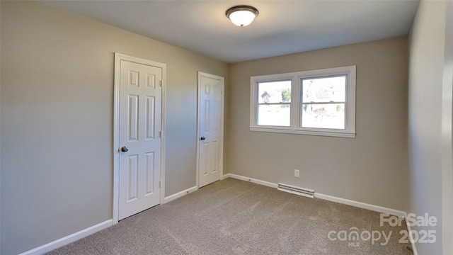 unfurnished bedroom featuring multiple closets and carpet