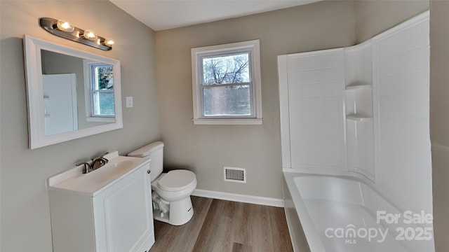 bathroom with hardwood / wood-style flooring, vanity, and toilet