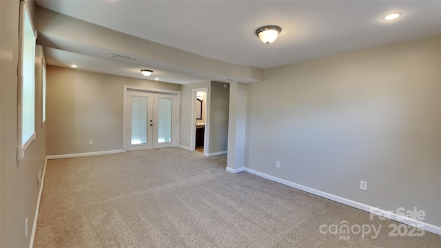 unfurnished room with french doors and light carpet