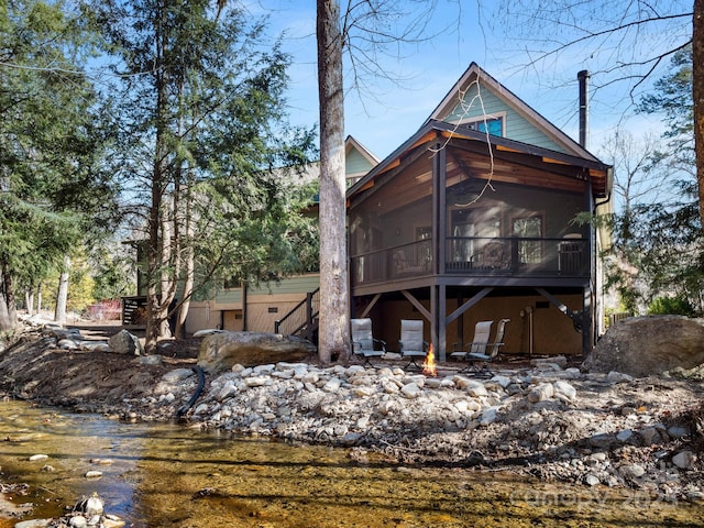 back of property with a sunroom