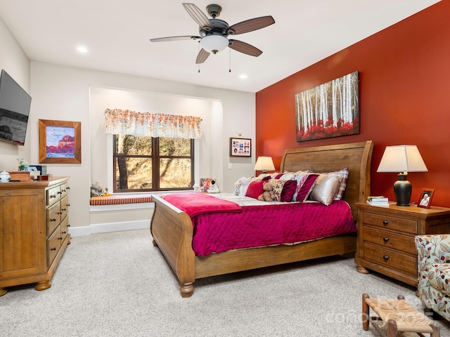 bedroom featuring light colored carpet and ceiling fan